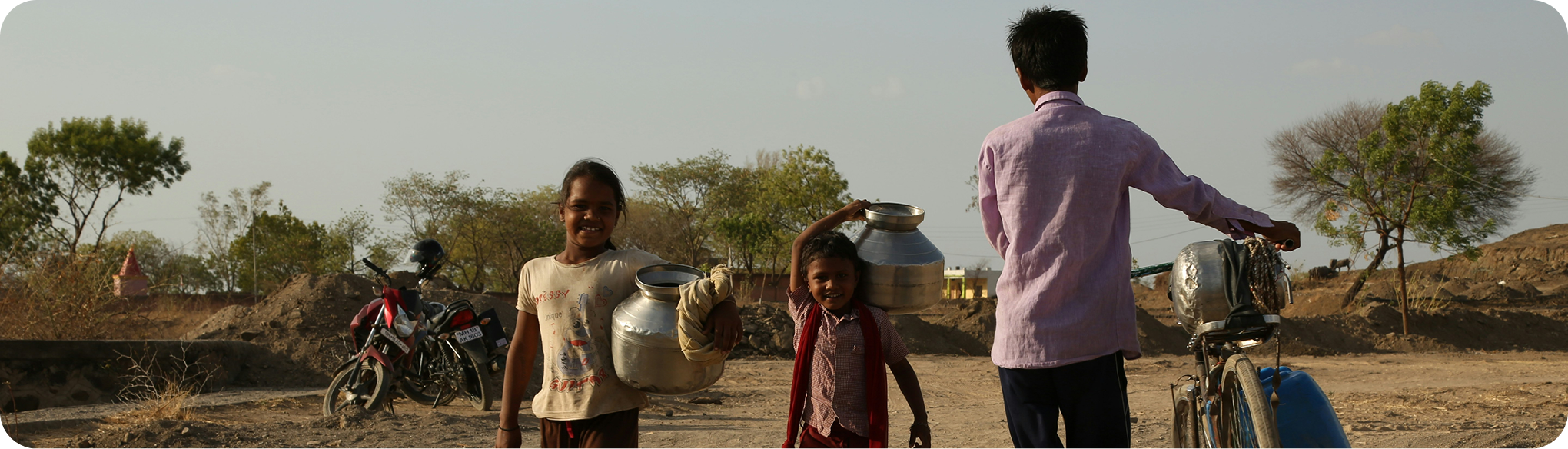 Family carrying water in a rural town